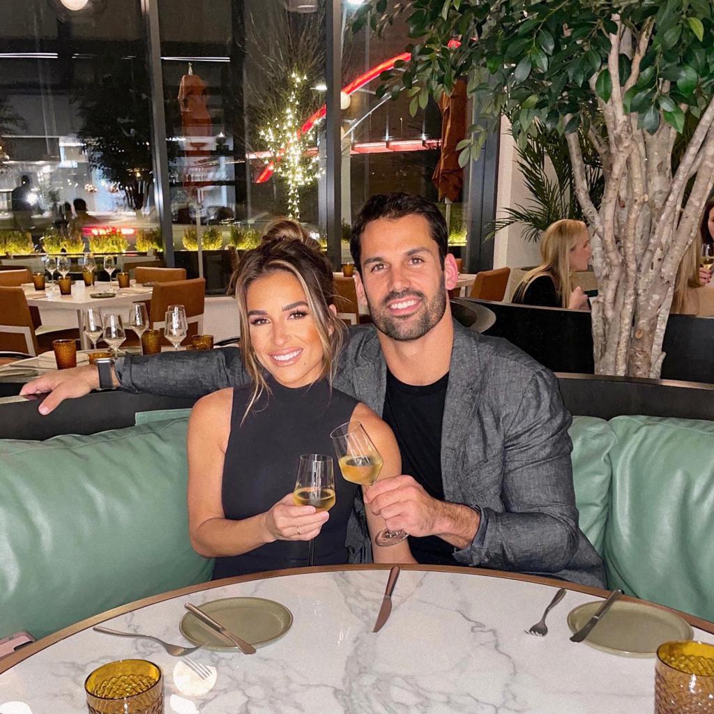 Jessie James Decker and Eric Decker hold wine glasses with a smile