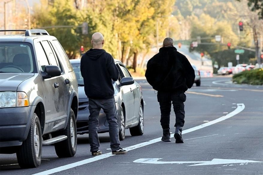 Kanye West confronting a paparazzi.