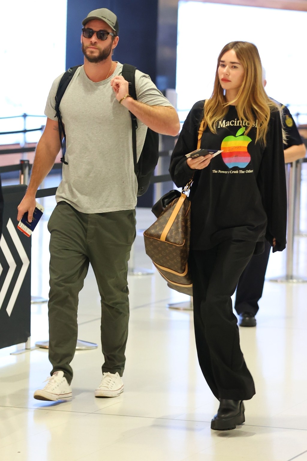 Liam Hemsworth and Gabriella Brooks in an airport.