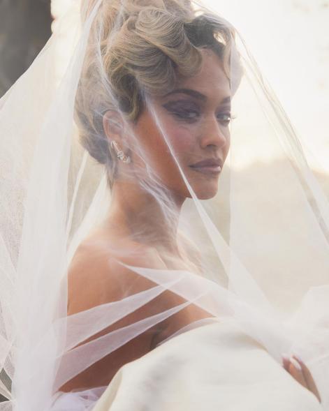 Rita Ora wearing a wedding dress.