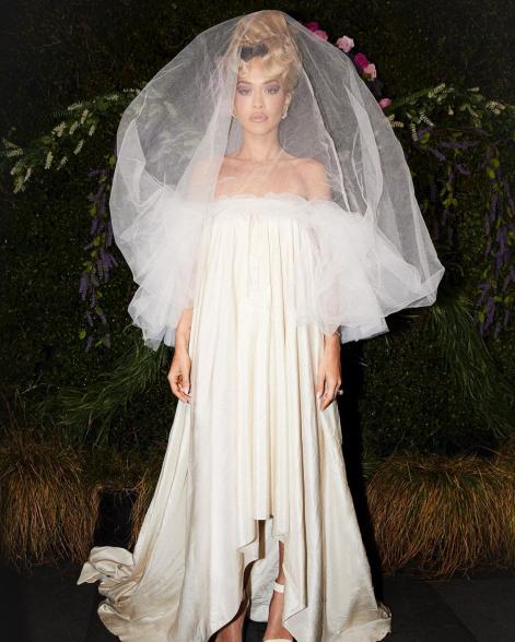 Rita Ora wearing a wedding dress.