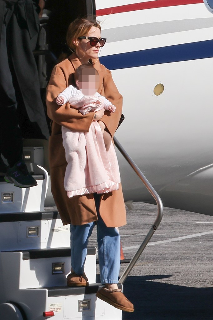 Riley Keough carrying her daughter 