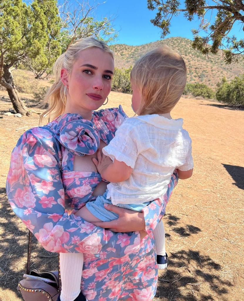 Emma Roberts wears floral dress holding son Rhodes