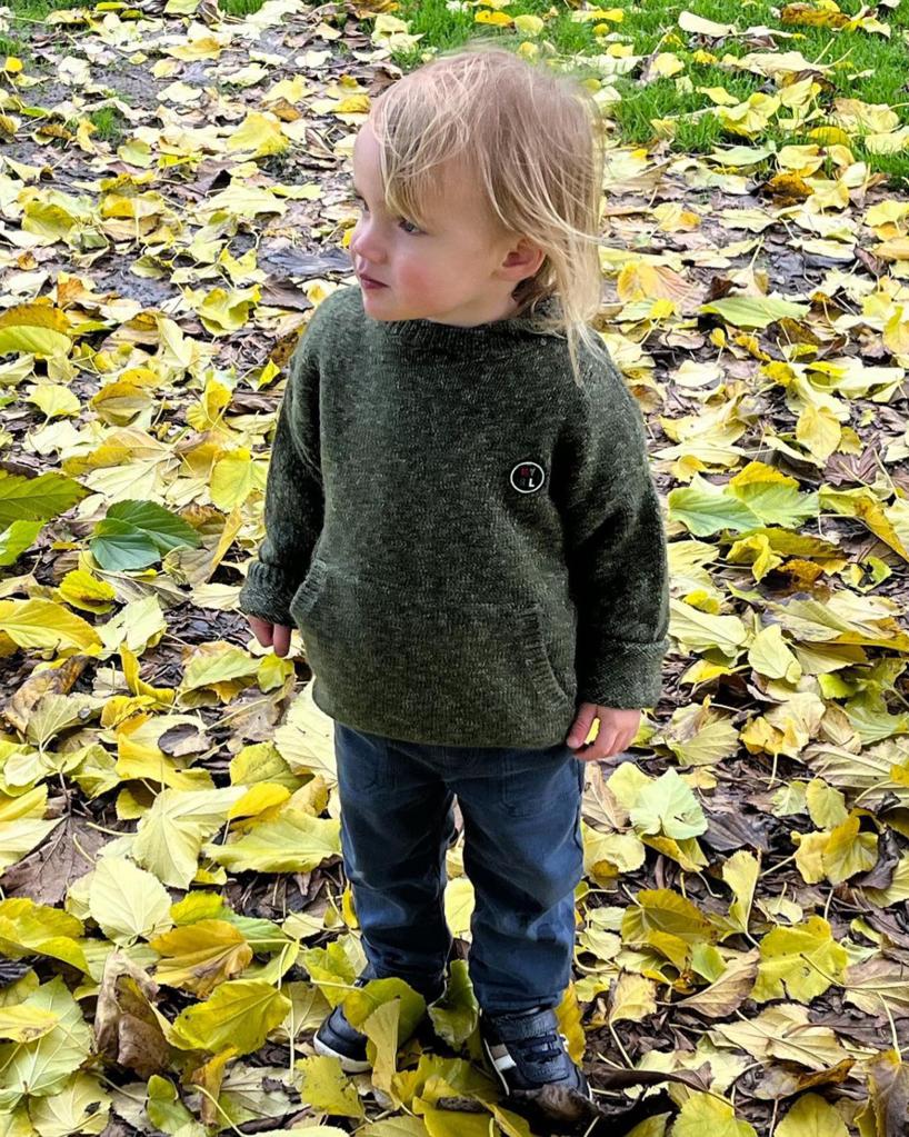 Emma Roberts' son, Rhodes, stands in leaves