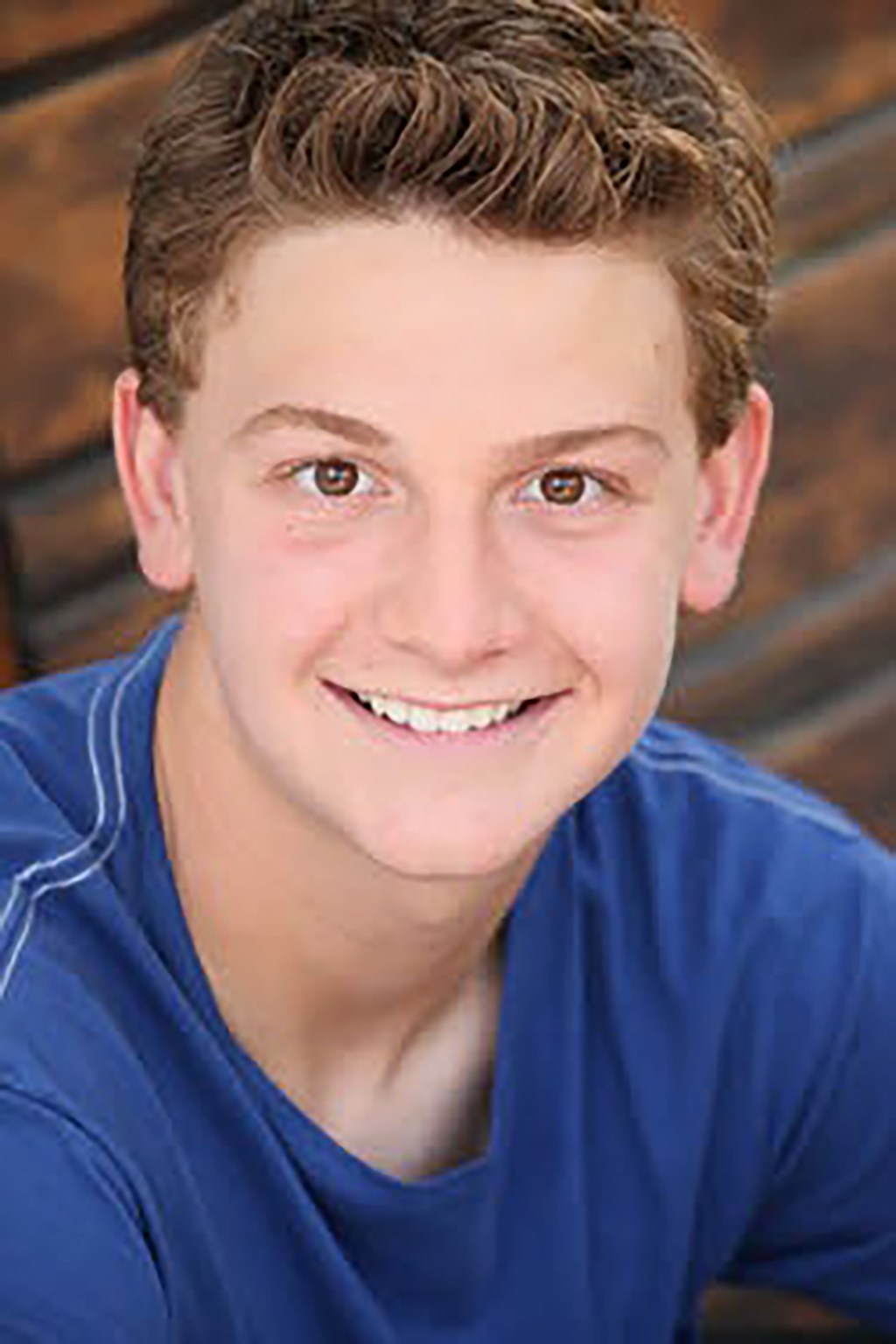 Austin Majors headshot in blue.