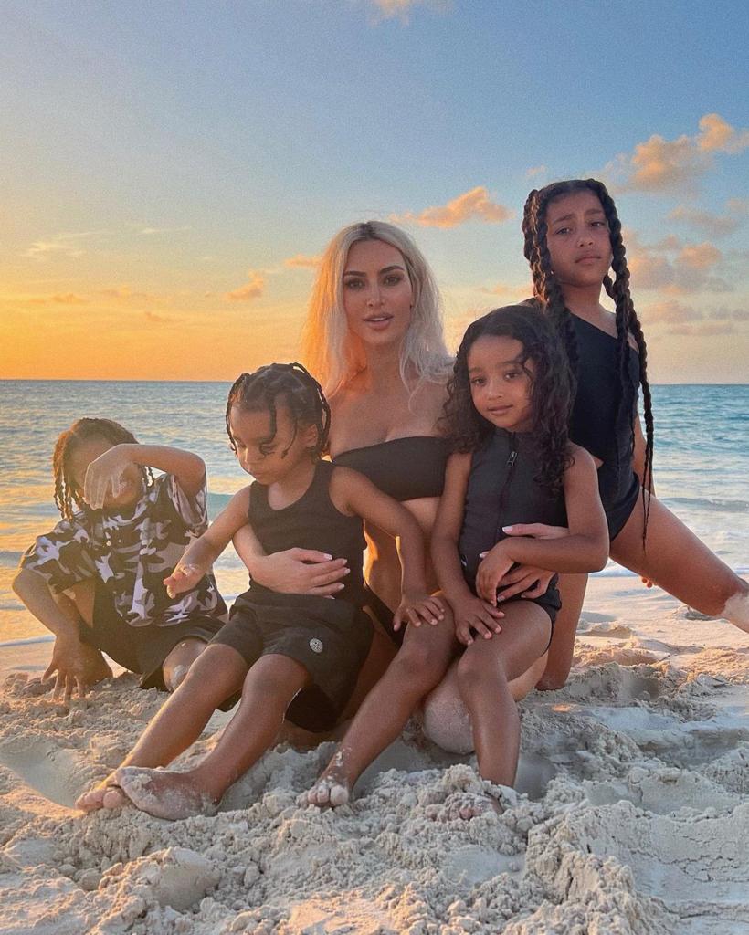 Kim Kardashian on the beach with her kids North, Saint, Chicago, and Psalm.