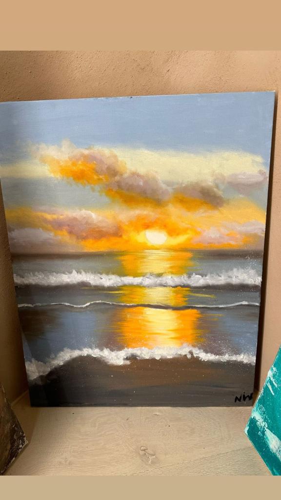 A painting of a sunset on the beach.