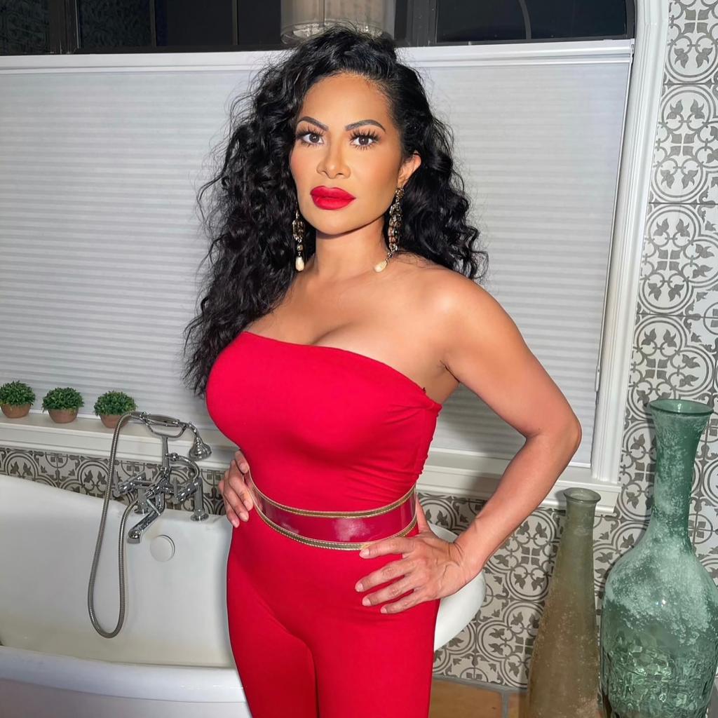 Jen Shah in a red jumpsuit and red lipstick.