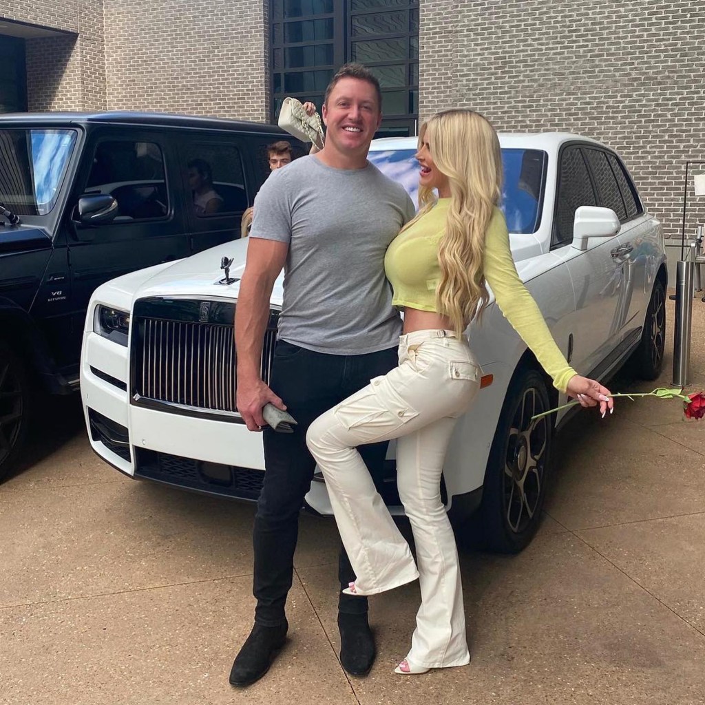 Kim Zolciak-Biermann posing with her husband, Kroy Biermann, in front of a car.