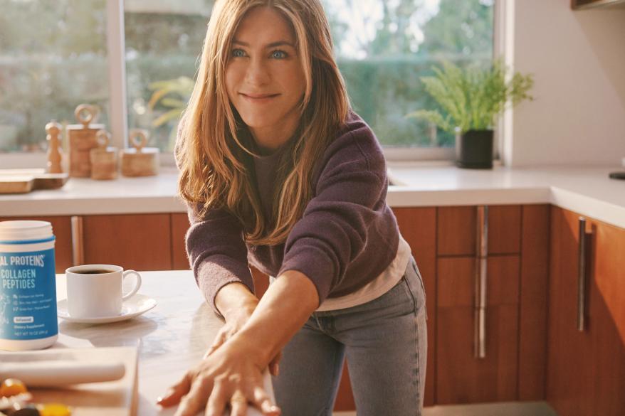 Jennifer Aniston leaning on a counter