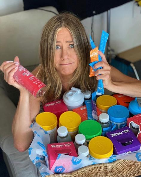 Jennifer Aniston with a basket of colorful Vital Proteinsproducts