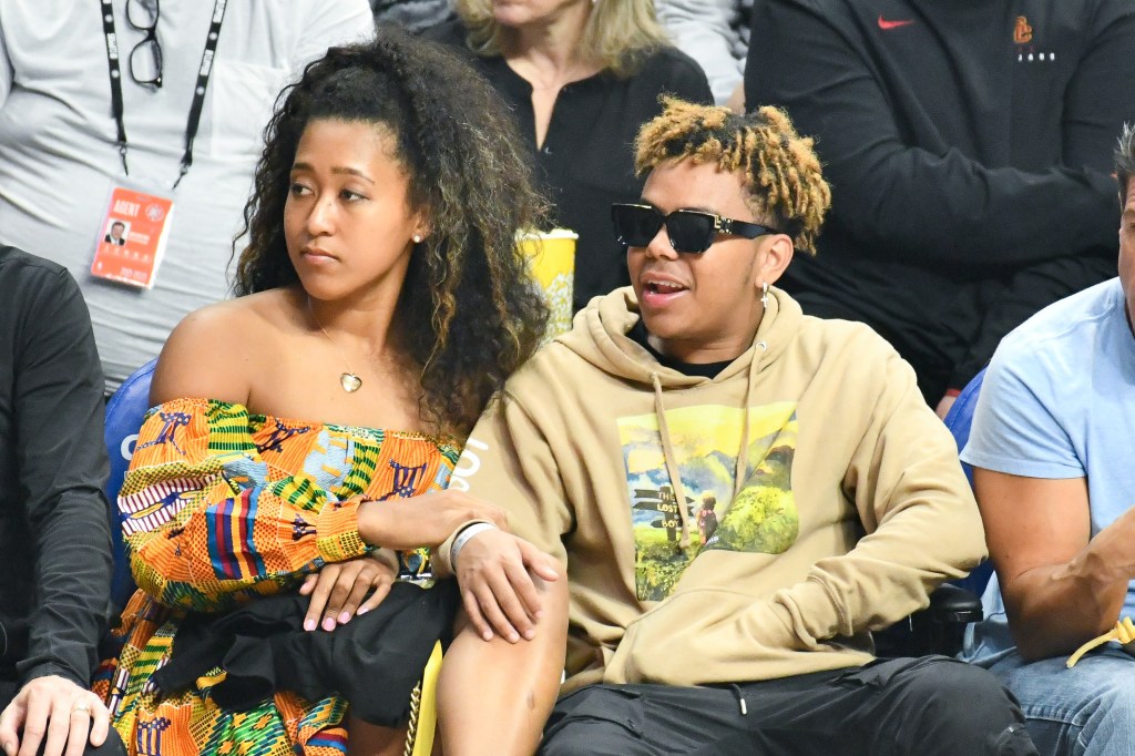 Naomi Osaka sits courtside with Cordae