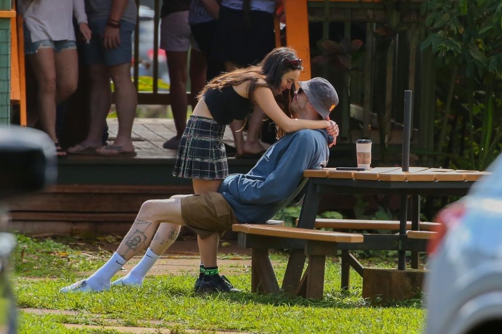 Pete Davidson and Chase Sui Wonders looking into each other's eyes while he sits on a bench in Hawaii.