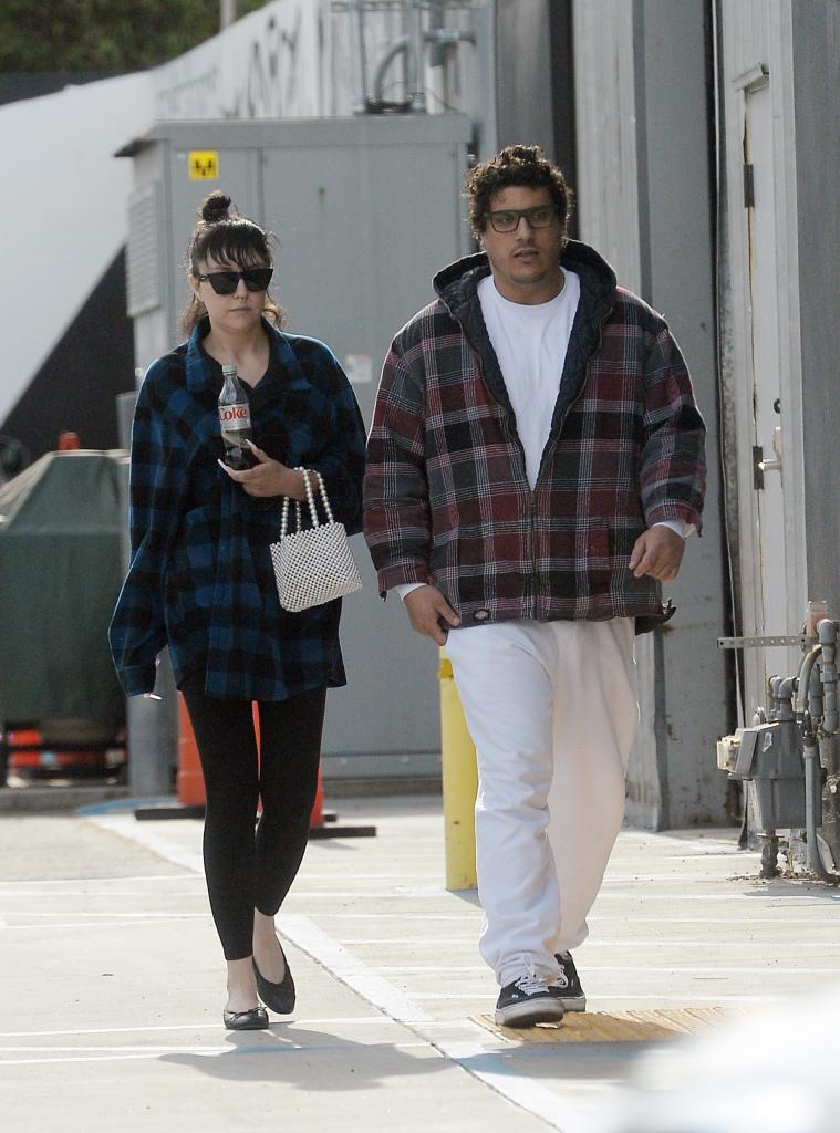 Amanda Bynes and Paul Michael walking together.