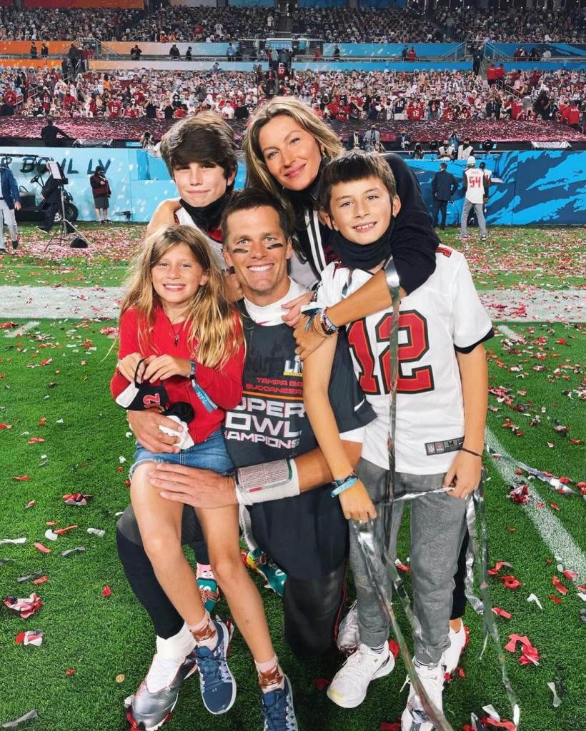 Tom Brady and Gisele Bündchen posing on the football field with all three kids: Benjamin, Vivian and Jack
