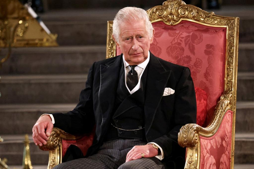 King Charles III sitting in a chair.