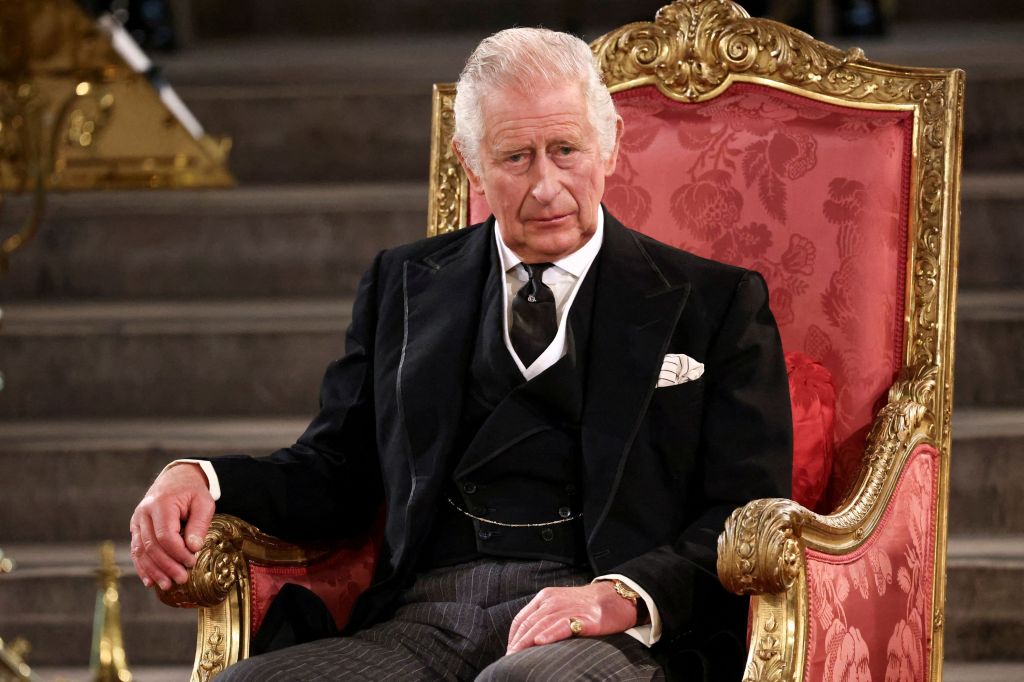 King Charles III sitting in a chair. 