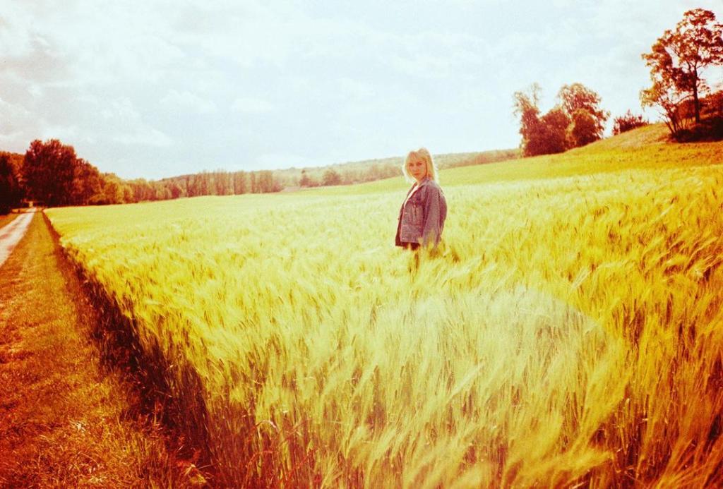 Jena Malone in a wheat field.