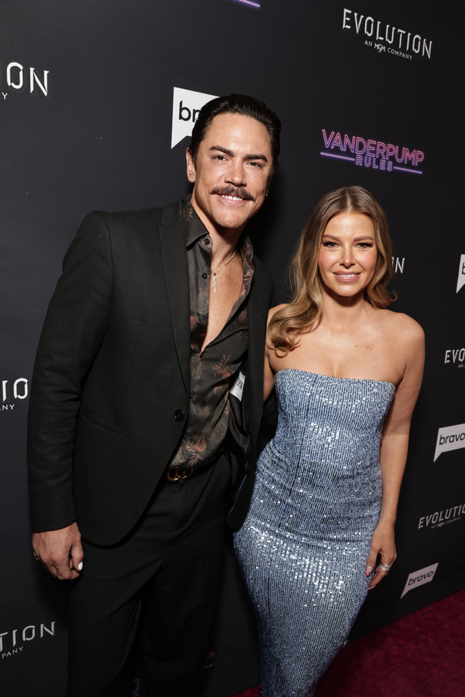 Ariana Madix and Tom Sandoval posing together on a red carpet.