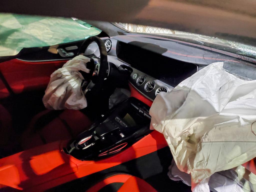 interior of a damaged car with the airbag deployed