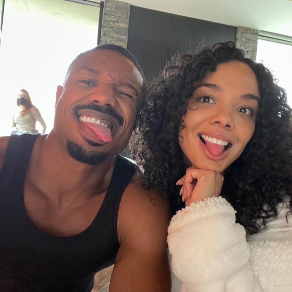 Michael B. Jordan and Tessa Thompson making funny faces in a selfie.