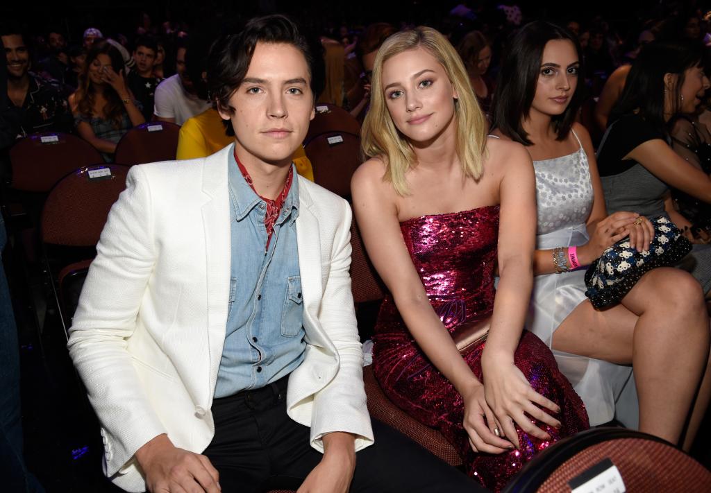 Cole Sprouse and Lili Reinhart sitting at an event together.