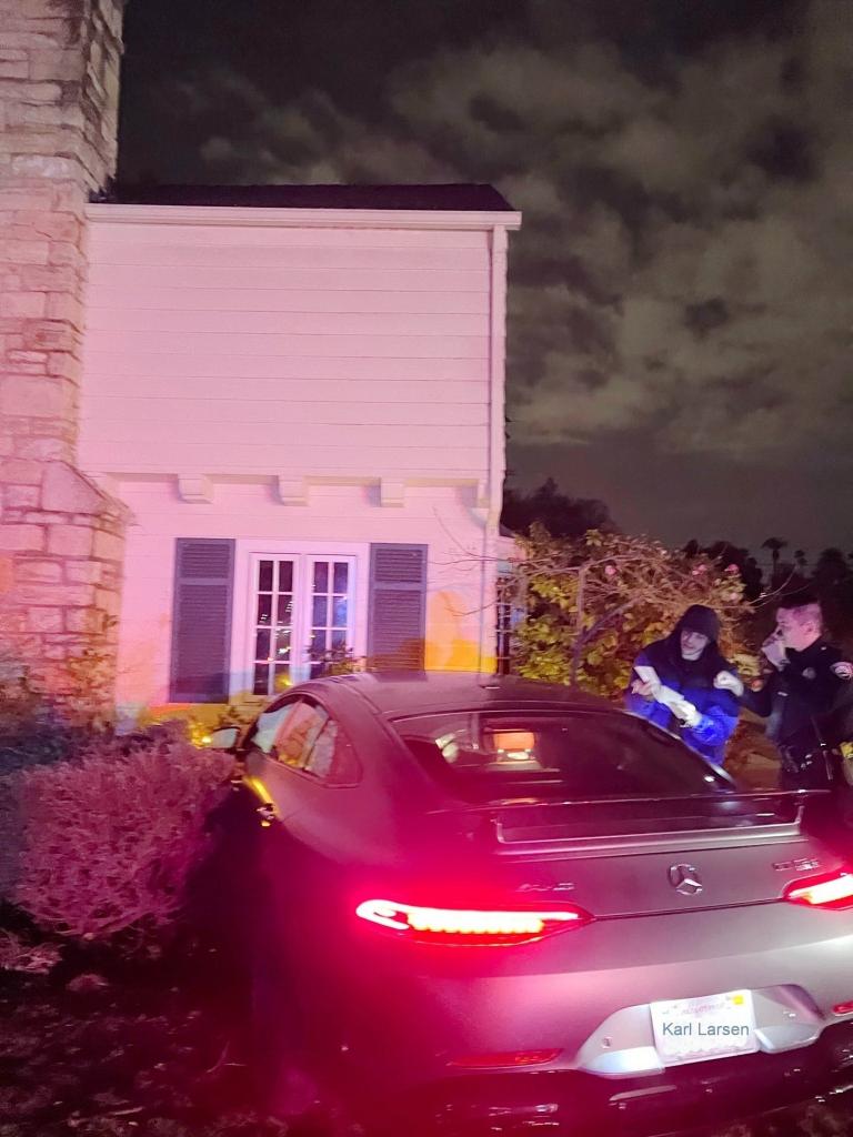 Pete Davidson next to his car crashed into a home.