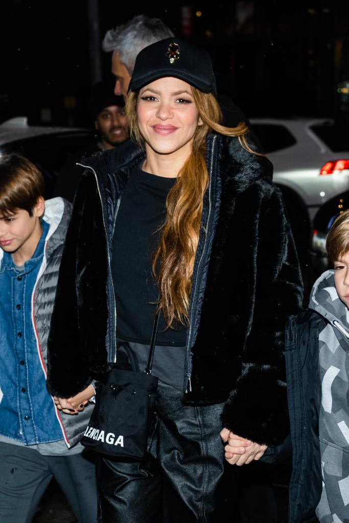 Shakira smiles with sons in black outfit