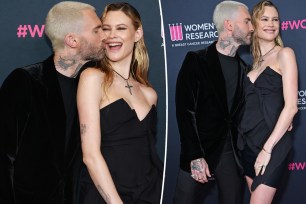 Adam Levine and Behati Prinsloo on a red carpet.