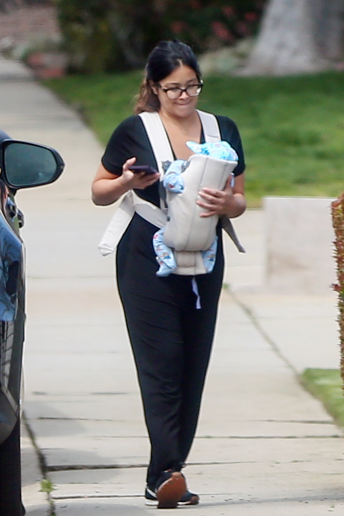 Gina Rodriguez carrying her newborn baby.