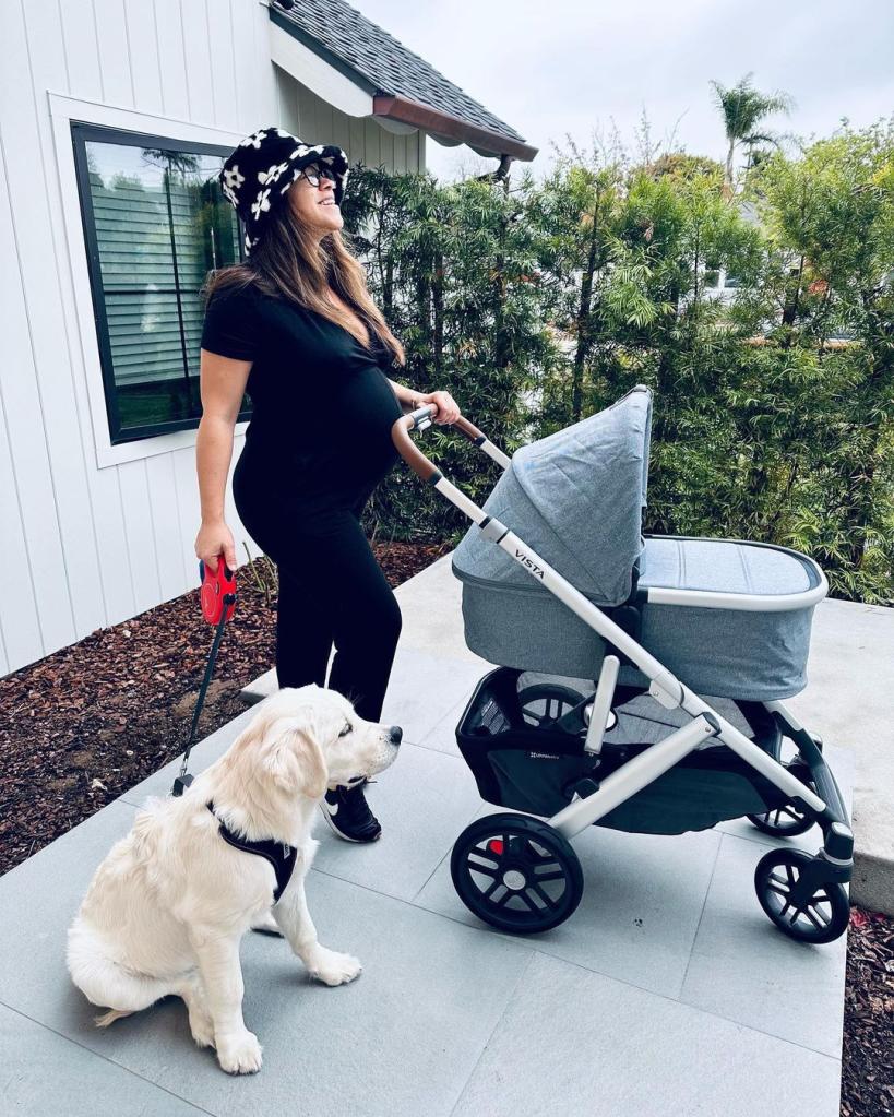 Gina Rodriguez posing with a stroller.