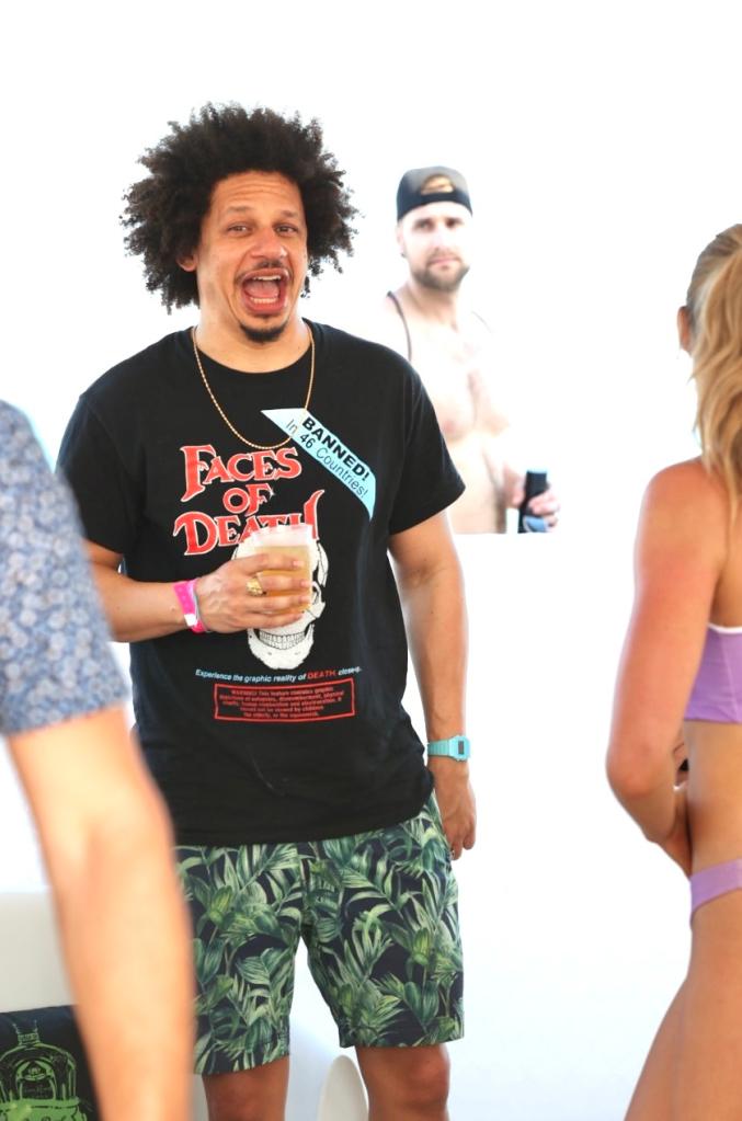 Eric André smiling at a model volleyball tournament.