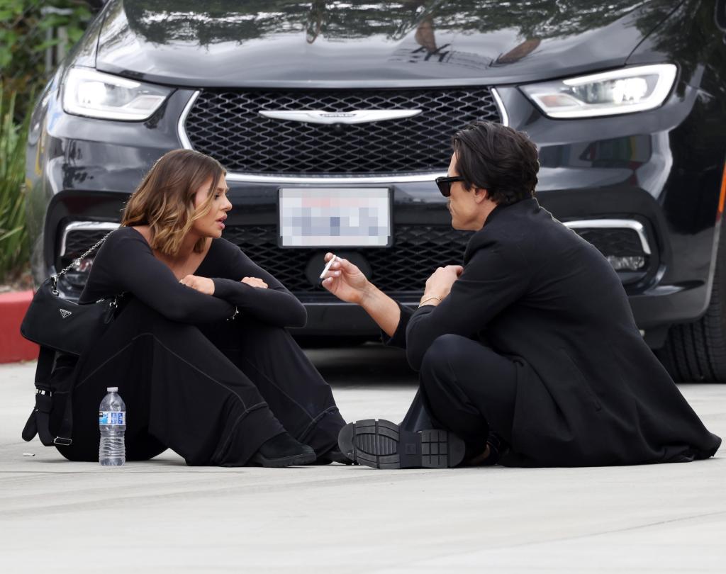 raquel leviss and tom sandoval sitting on concrete