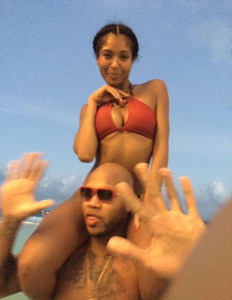 Alexis Adams sitting on Flo Rida's shoulders.