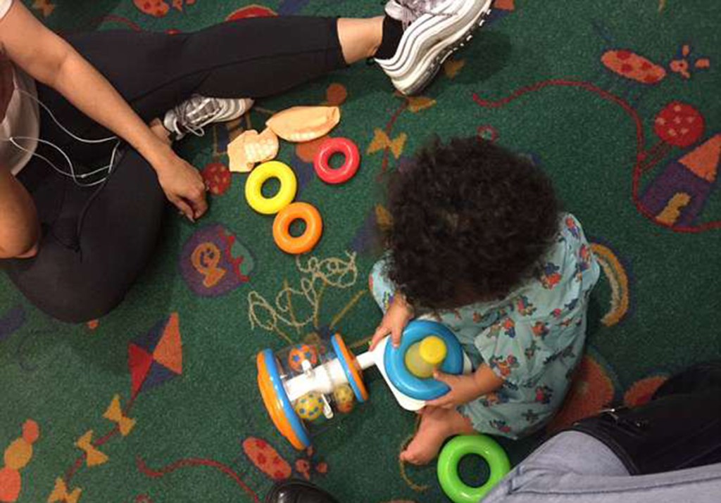 Flo Rida's son playing with toys on a floor.