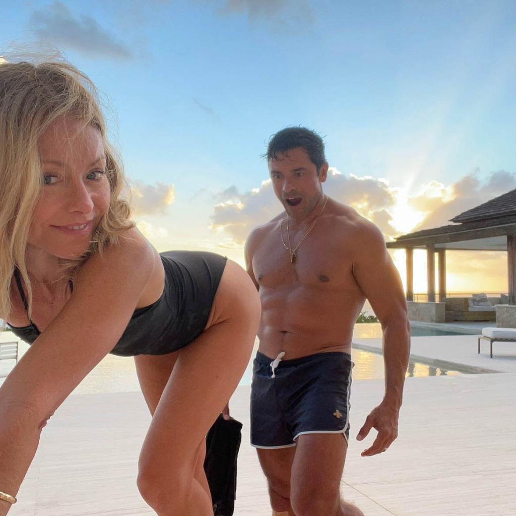 Ripa bends over in front of Consuelos as he stares in shock at her bum while on the beach