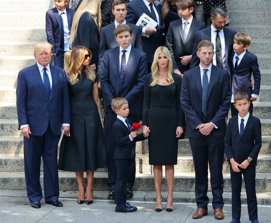 donald trump's family posing in front of stairs