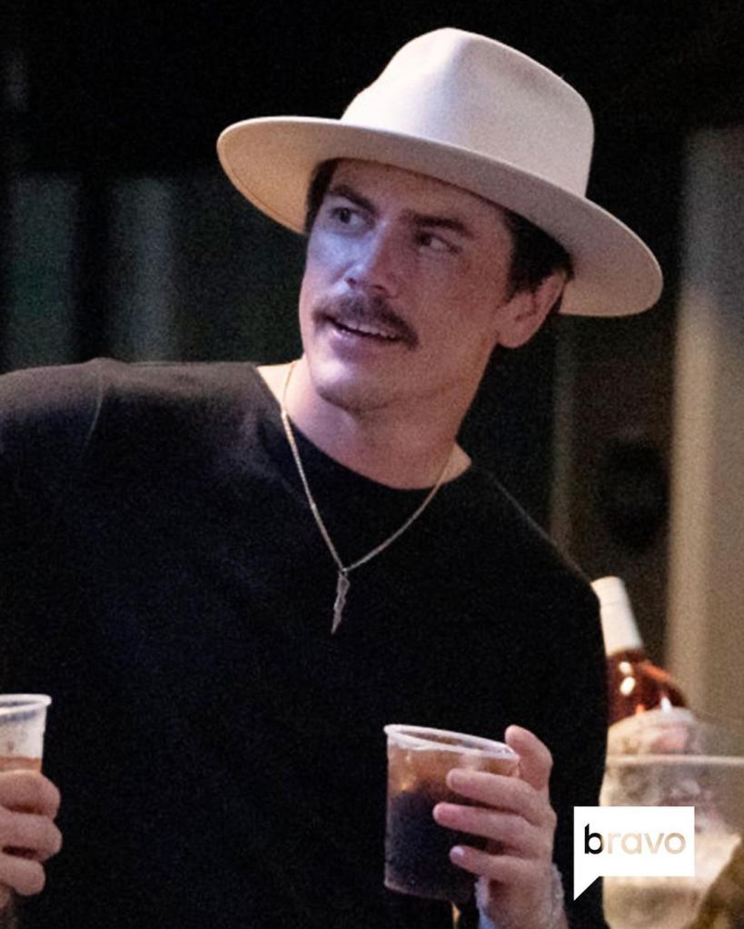 Tom Sandoval drinks in hat