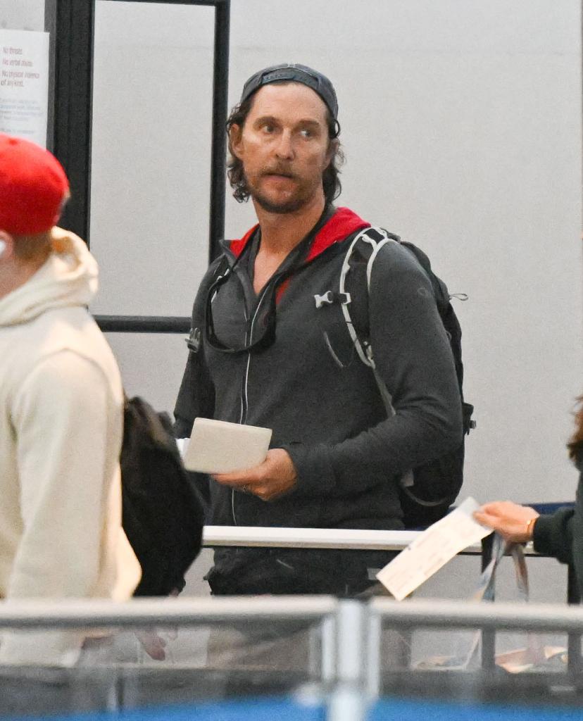 Matthew McConaughey walks with backpack