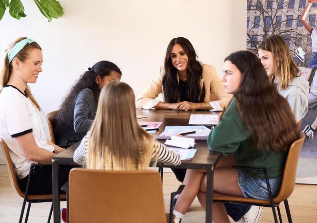 Meghan Markle at a table with employees.