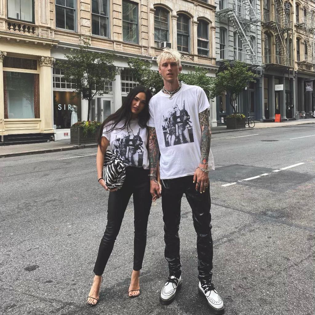 Machine Gun Kelly and Megan Fox standing in the street.