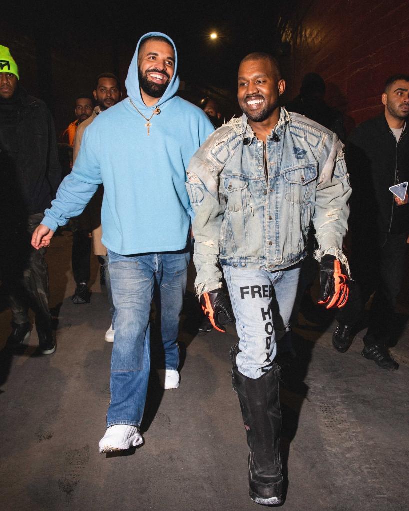 Kanye West and Drake walking together.