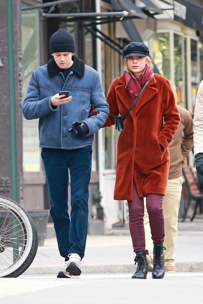 Joe Alwyn and Taylor Swift walking together in the streets of New York City.