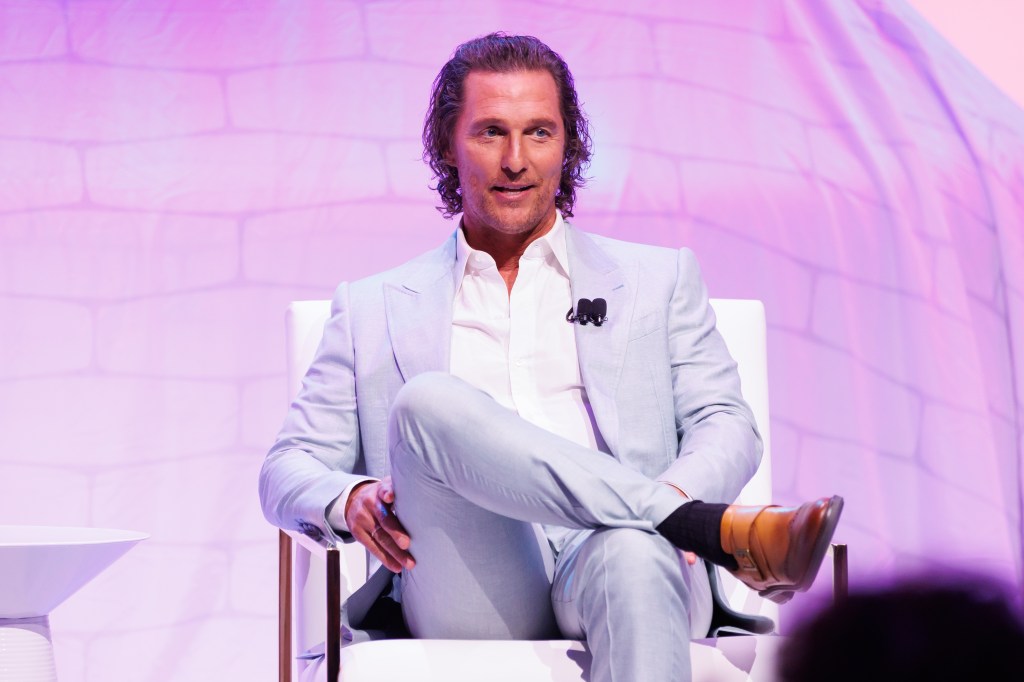 Matthew McConaughey sits in suit