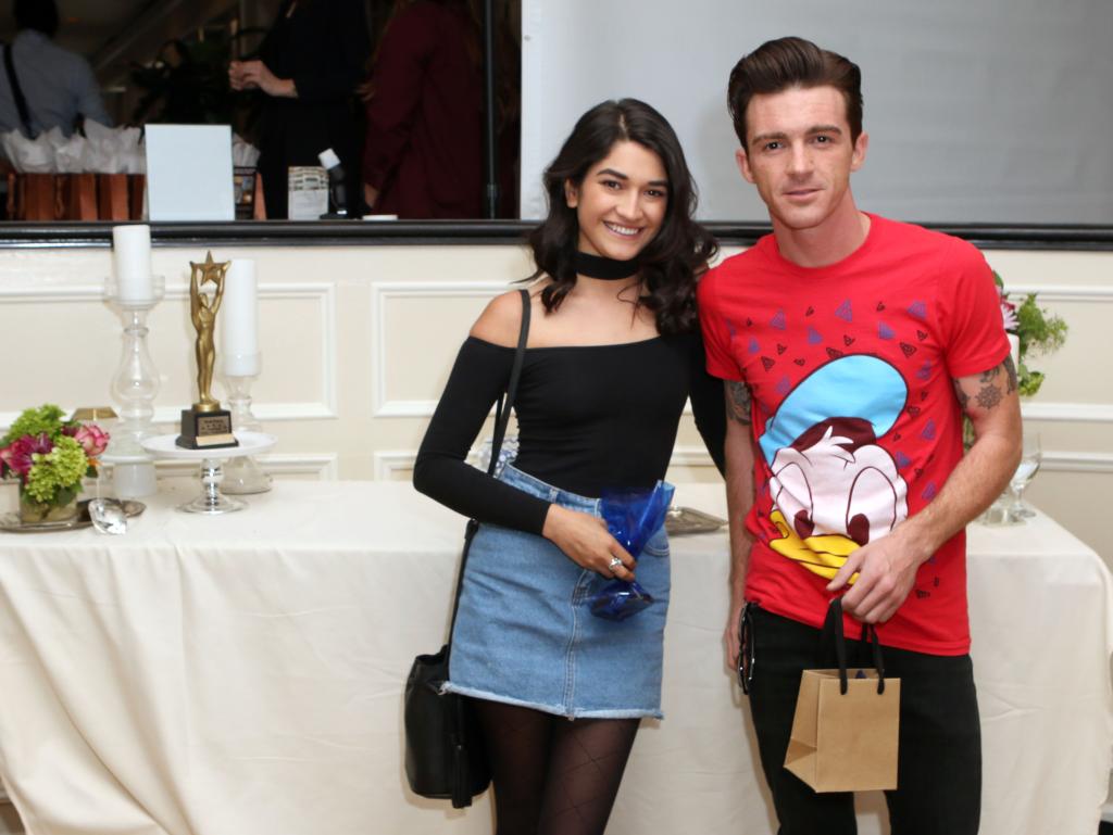 Drake Bell and Janet Von Schmeling posing for a photo together.