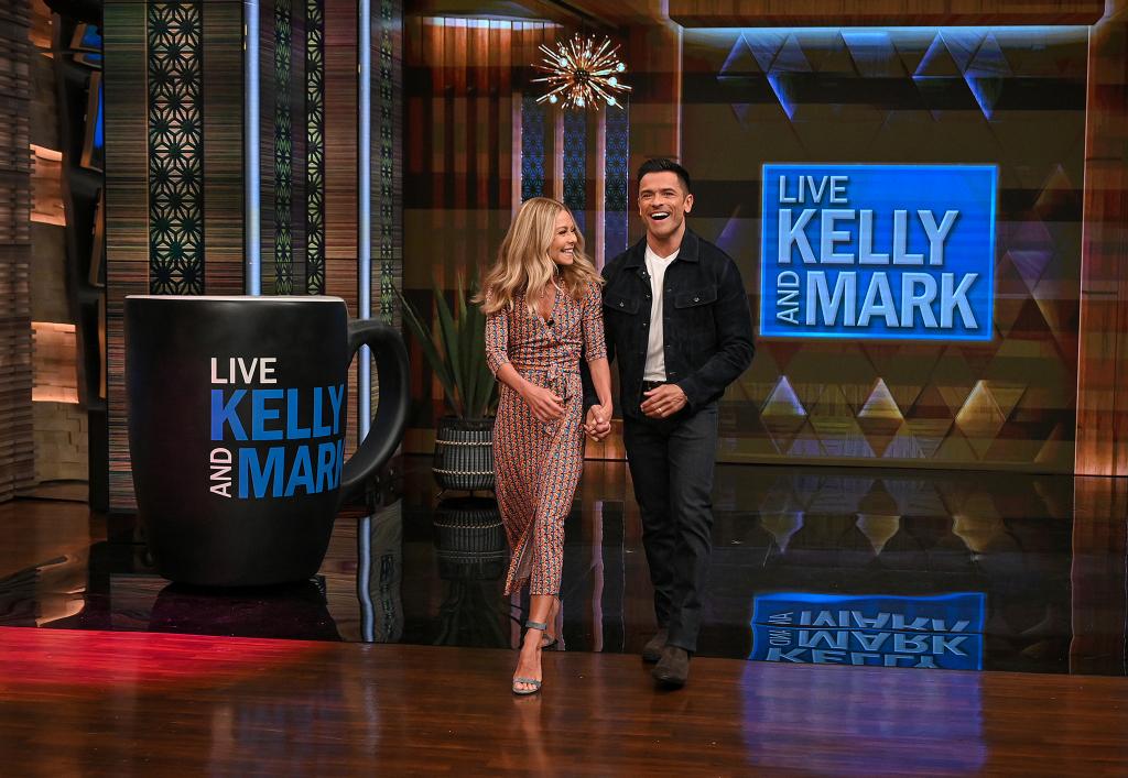 Mark Consuelos and Kelly Ripa walking onto "Live with Kelly and Mark"