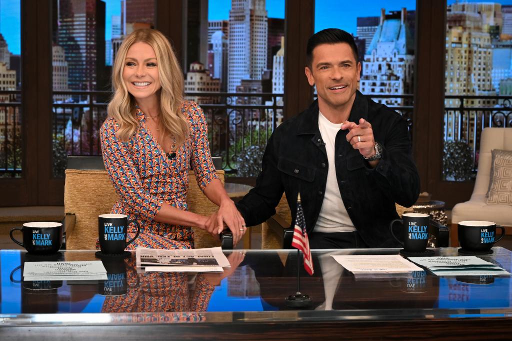 Kelly Ripa and Mark Consuelos sitting on "Live with Kelly and Mark"