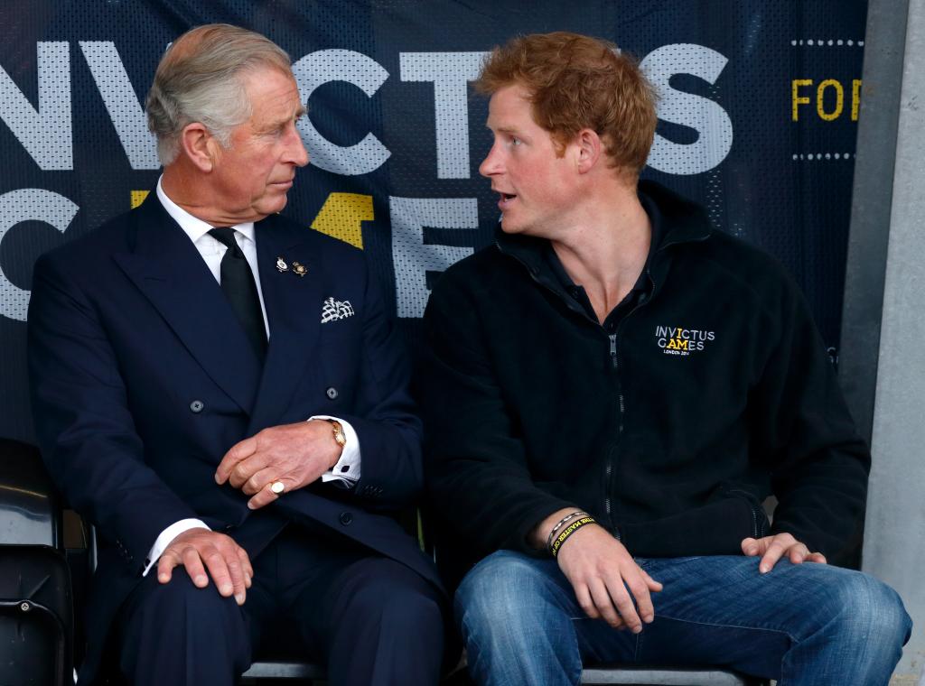 King Charles and Prince Harry looking at each other while at an event.