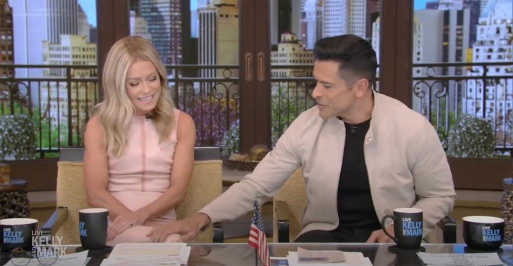 Kelly Ripa and Mark Consuelos sitting on "Live with Kelly and Mark"