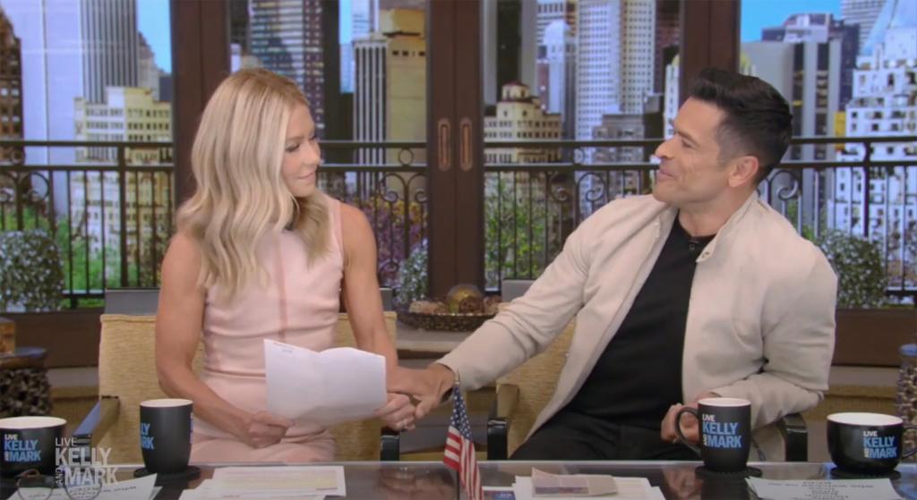 Kelly Ripa and Mark Consuelos sitting on "Live with Kelly and Mark"